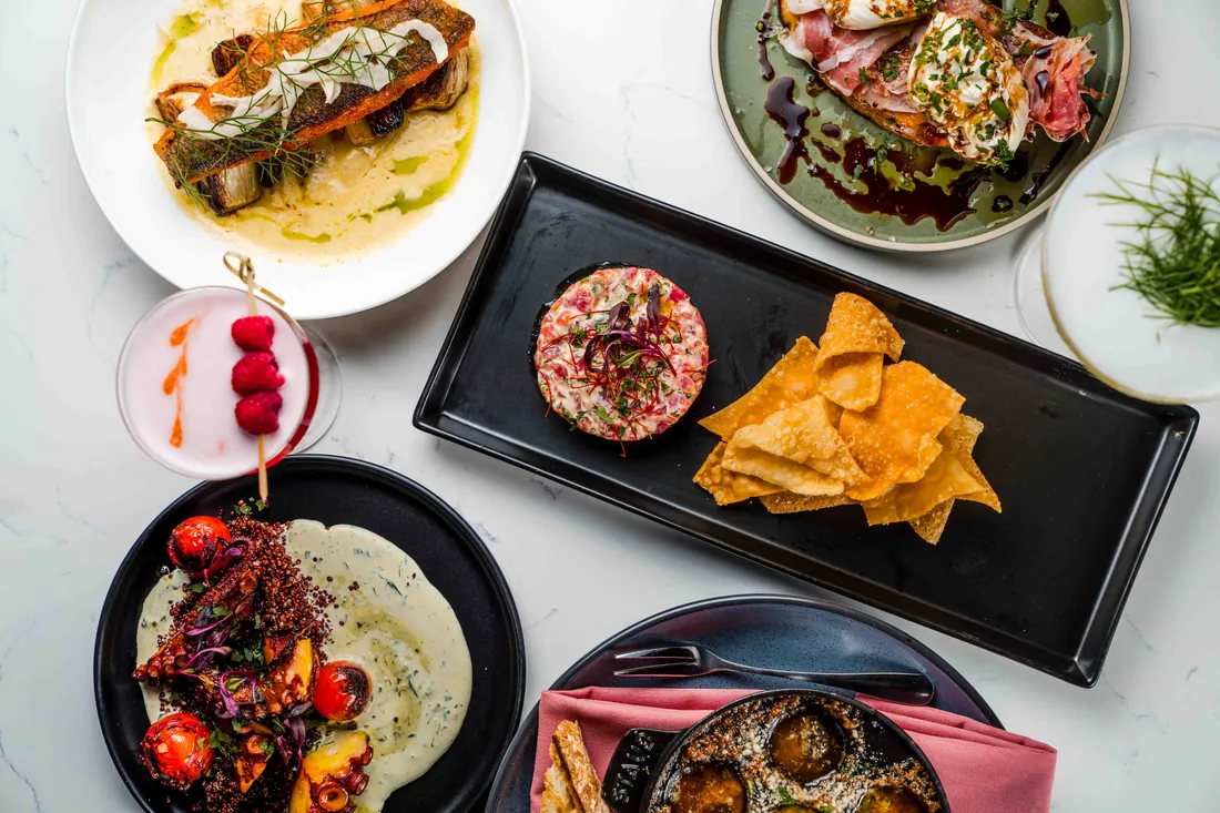 Overhead spread of shared plates and dips